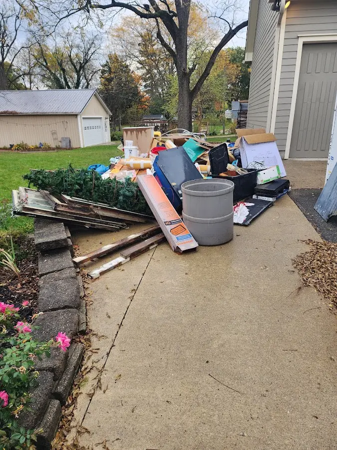 Dumpster being loaded with debris for Estate Cleanout Dumpster Rental in Perkins